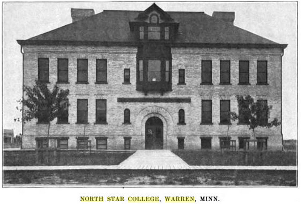 Black and white photo of North Star College in Warren, MN; a three-story stone building with black hip roof, ornate dormer window, and arched main entrance, with two young trees in front